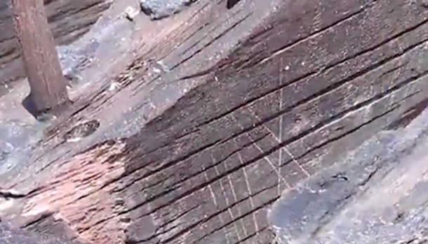 The wooden pegs can be seen on the left, and the Roman numerals were carved into the sides of the hull ribs, seen center. (Screengrab: AJC.com)