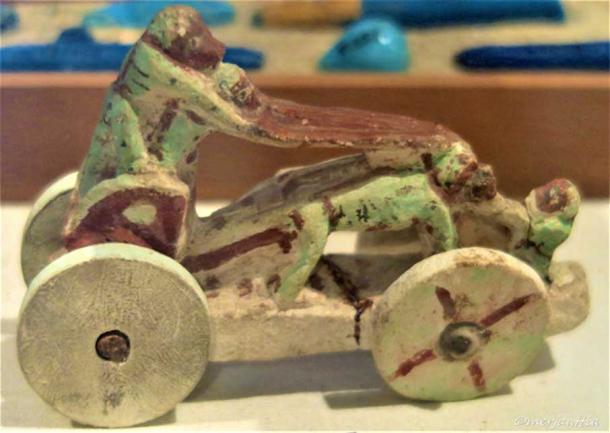 This toy is made of painted sandstone and depicts three monkeys, two on the left side and one on the right. They are stretching a robe above the horses’ heads. All the figures are resting on a chariot with four wheels. 18th Dynasty. Tell el Amarna. Egyptian Museum, Cairo.