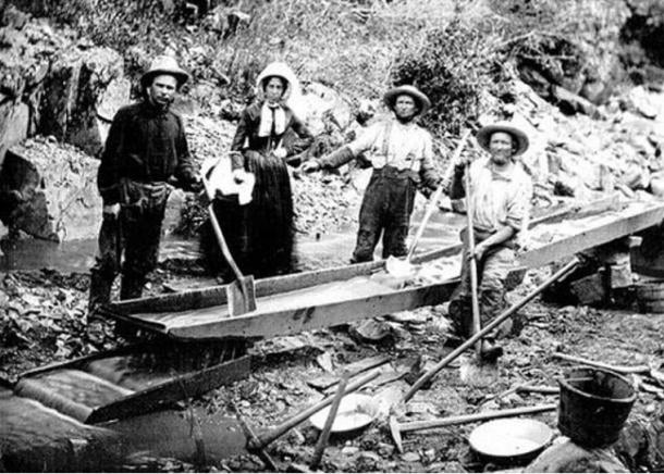 Three men and one woman panning for gold during the California Gold Rush (Public Domain)