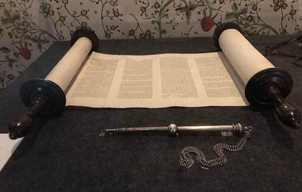 A hand-written Sefer Torah, or Torah Scroll, with a yad pointer stick before it. Now in the State Library of Victoria. (Azoma, CC BY-SA 4.0)