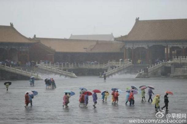 Tourists stream into the ancient Forbidden City in Beijing on July 20, as violent rainstorms ground the capital of China to a halt.