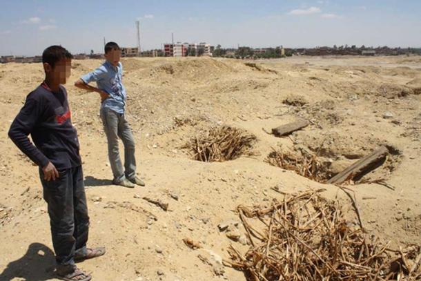 Two children in the looted cemetery at Abusir el-Malek, Egypt.