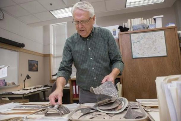 UC archaeologist Alan Sullivan examines sherds of pottery from sites outside Arizona’s Grand Canyon National Park (Image: Joseph Fuqua II/UC Creative Services)
