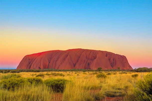 Shot of Uluru just after sunset, where the Aboriginal rock art can be found. (bennymarty / Adobe stock)