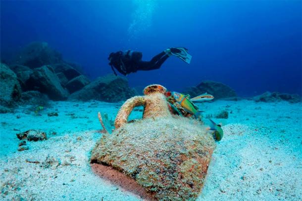 Underwater archaeology involves the excavation of submerged remains, including shipwrecks, sunken cities and other ancient artifacts. Representational image of a diver with a Greek amphora. (moofushi / Adobe Stock)