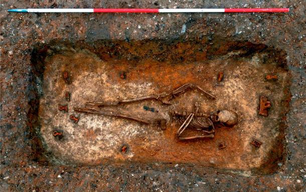 Unearthed during excavations conducted by the Cambridge Archaeological Unit near Trumpington, this young woman was laid to rest in a unique 'bed burial' dating back to the 7th century. The surrounding area showcases visible remnants of the metal fixtures that were once used to secure the furniture. University of Cambridge Archaeological Unit
