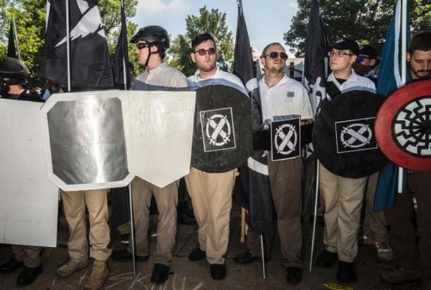 White supremacists standing by the statue of Robert E. Lee, before the crash in Charlottesville. Credit: Go Nakamura