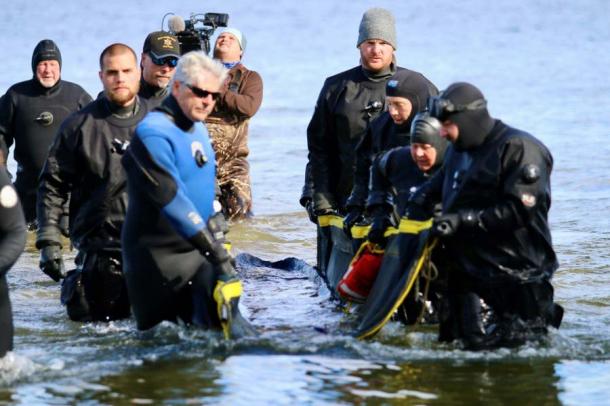 The Wisconsin dugout canoe emerges from Lake Mendota after lying for 1200 years or so underwater on the lake floor. (Wisconsin Historical Society)