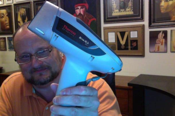 J. Hutton Pulitzer holding an XRF machine.