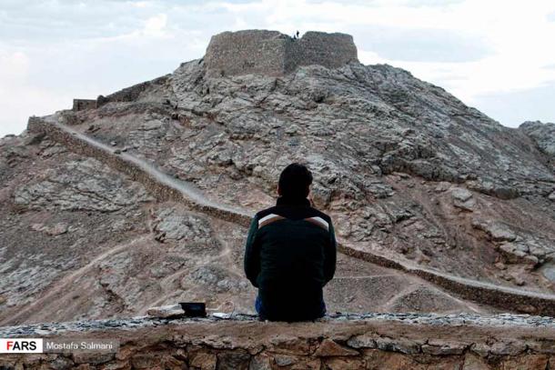 A lone modern Zoroastrian at Dakhmeh Zartoshtian (Zoroastrian Towers of Silence) in Yazd, Iran. (Fars News Agency / CC BY 4.0)