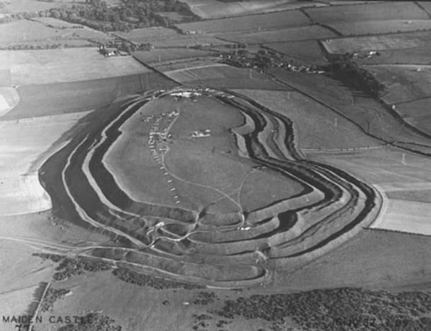 An aerial view of Maiden Castle in Dorset from the west taken by Major George Allen in October 1937, which is part of the Ashmolean Museum's photographic collection. Like the Scottish hillfort Broxmouth settlement, Maiden Castle site has produced a range of everyday objects buried with or without the dead in sites dating from the Iron Age in Britain. (Major George Allen (1891–1940) / Public domain)