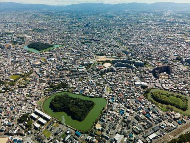 An aerial view of the Mozu-Furuichi Kofun Group, a group of one hundred and twenty-three kofun or tumuli in Fujiidera and Habikino, Osaka Prefecture, Japan. Thirty-one of the burial mounds are keyhole-shaped, thirty round, forty-eight rectangular, and a further fourteen are of indeterminate shape. (Claude Jin / Adobe Stock)