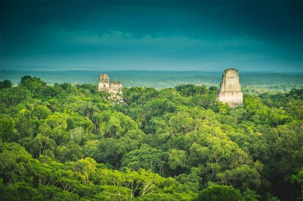 The ancient city of Tikal rises above the rainforest in northern Guatemala. (Ai /Adobe Stock)