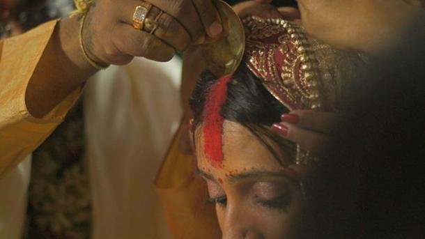 he ritual of applying the Sindoor (a traditional cosmetic powder) as part of a Hindu Indian wedding.