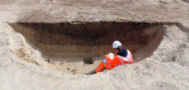 An archaeologist logging one of the huge pits. (MOLA)