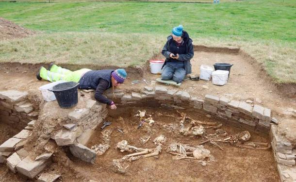 Scottish archaeologists examining the Neolithic tomb and artifacts discovered. (National Museums Scotland)