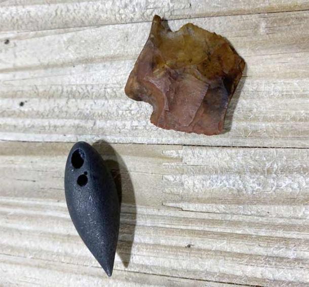 The two artifacts found in the Mississippi alligator’s stomach: the 6,000-BC atlatl dart point (top), and the black plummet stone from 1,700 BC (bottom). (Shane Smith / Clarion Ledger)