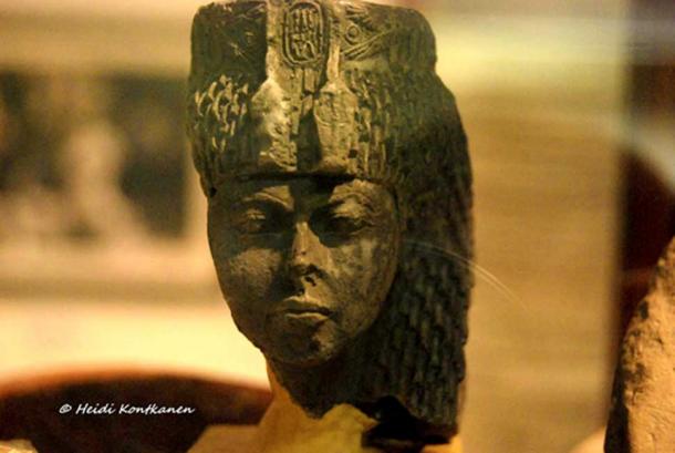 The astute and stern matriarch: Small greenstone head identified as Queen Tiye by her cartouches and distinctive uraei headdress. Found by Flinders Petrie in the Sinai (1904). Petrie Museum, London (Original artifact at the Egyptian Museum, Cairo.)