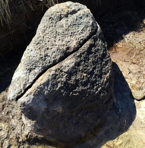 A blackened rock said to be the hearth. Slag was found around the boulder.