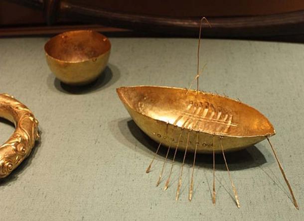 The boat, bowl, and part of a torc.