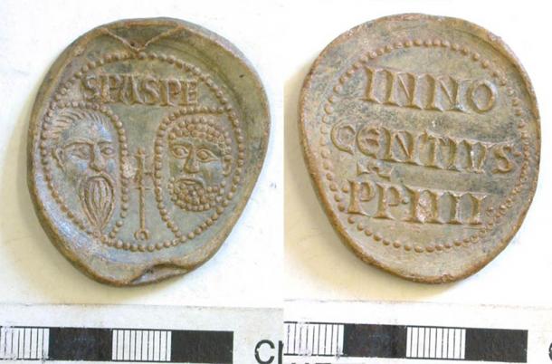 Lead papal bulla of Pope Innocent IV (1243-54). (CC BY SA 2.0) One face bears the conventional stamped busts of Saints Peter and Paul both within drop-shaped pelleted borders, possibly haloes. On the reverse are the words INNOCENTIVS PP IIII. The PP stands for Pastor Pastorum, meaning shepherd of the shepherds.