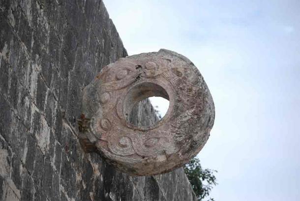 A carved stone decorative ring is embedded in the wall of a ballcourt at Chichen Itza. (LanaCanada/UC)