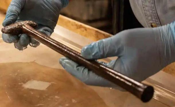 The ceremonial warrior’s axe found with the Bronze Age coffin in a pond at the Tetney Golf Club. This image shows the axe in the condition it was found before it was cleaned. (Charlotte Graham / York Archaeological Trust)