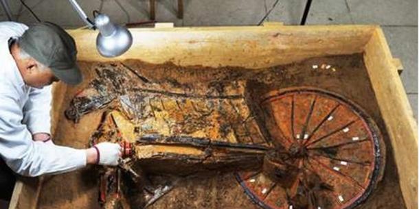 A chariot from the tomb being cleaned. 