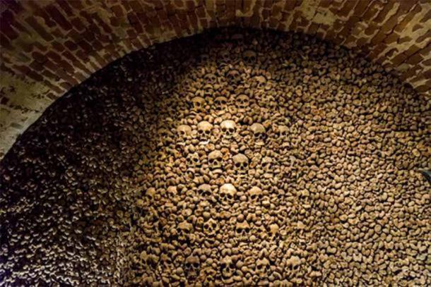 Skulls and bones from charnel house. (Martin / Adobe)