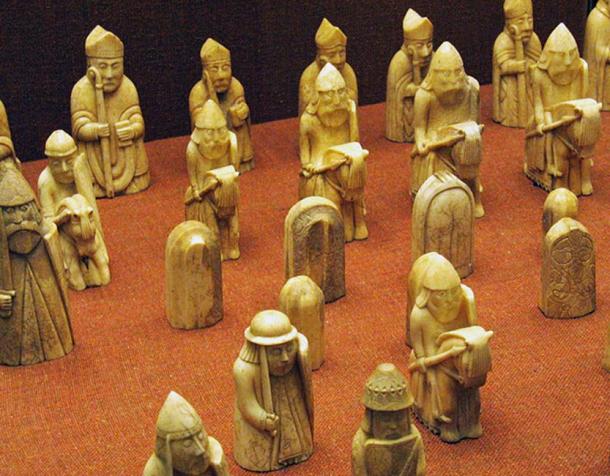 A selection of chess pieces, with a row of Bishops at the back, then a row of Knights.