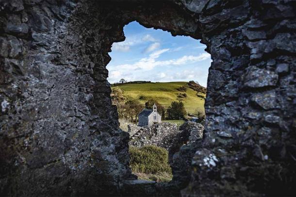 The view of a small church from the ruins of the Rock of Dunamase in Ireland. (MichaelG / Adobe Stock)