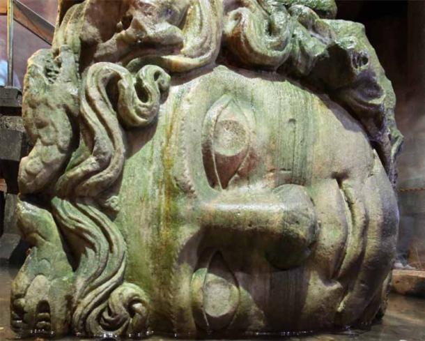 A closeup of one of the two giant Medusa heads in the Basilica Cistern beneath modern Istanbul.  Rumors spread that Medusa's sarcophagus stood here (Matthias Suessen / CC BY 3.0)