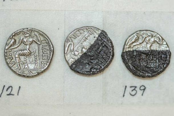 A closeup of three of the silver coins in Mleiha coin hoard. (Sharjah Archaeology Authority)