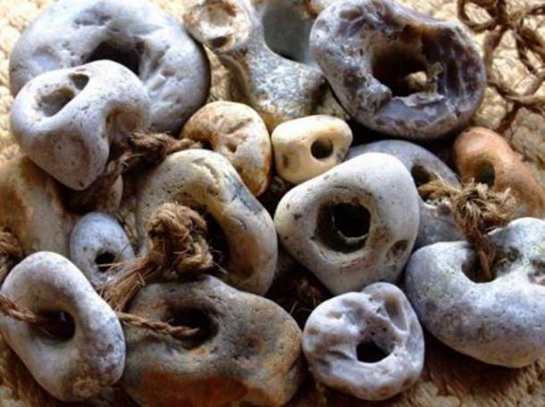 A collection of threaded Adder Stones. 