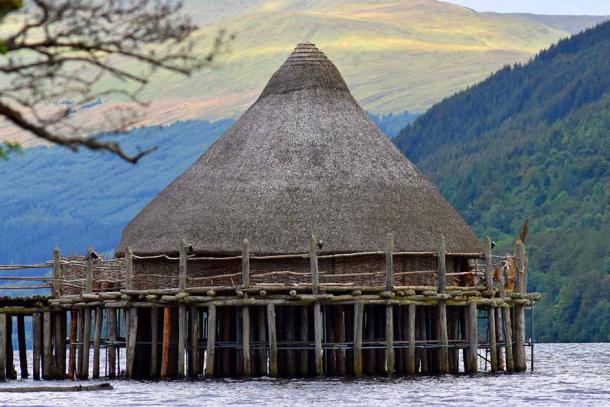 Just one of countless Iron Age crannogs that once dotted the Scottish Highlands (this one is a faithful reconstruction), which have now been proven to have developed into elite party palaces in the medieval period. (DMac / Adobe Stock)