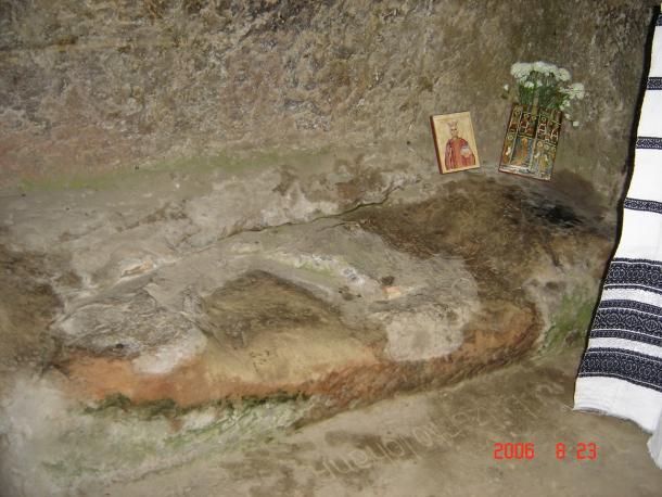 The worn stone bed carved in the rock.