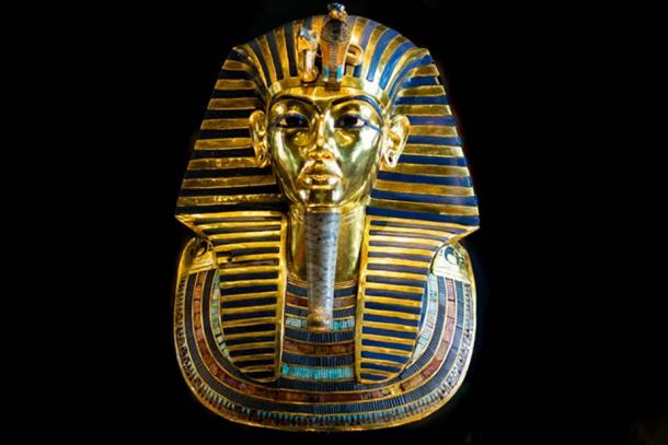 The dazzling golden mask that was found on the mummy of the boy-king Tutankhamun. The headpiece is embellished with inlays of both glassy material and a range of semi-precious stones. These include obsidian and white quartz (for the eyes), lapis lazuli (for the eye surrounds and eyebrows), and turquoise, amazonite, carnelian, and other stones (as inlays of the broad collar). Egyptian Museum, Cairo. 