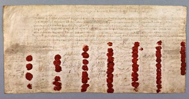 The death warrant for King Charles I of England in 1649, with 59 red wax seals of the judges who signed it (Public Domain)