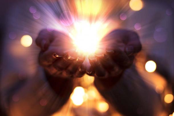 An image of energy transferal depicting the flow of magical energy emanating from female hands. It was “dark” energy transferal that brought 55 people together to put a curse on one person, according to the witchcraft in Athens research study. (Laura Сrazy / Adobe Stock)