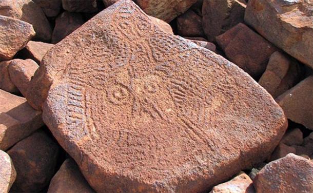 Los enigmáticos rostros arcaicos que se encuentran en gran número en Burrup se encuentran entre las primeras obras de arte rupestre de la región. Puede ser una de las caras talladas más antiguas del mundo (Imagen: Ken Mulvaney)