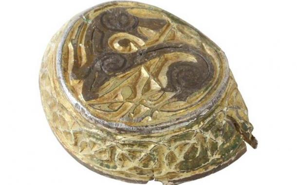 The enigmatic item was discovered in a crumpled state, yet it maintains a round shape with shallow sides, creating a dish-like form. (ANDREW WILLIAMS/NORFOLK COUNTY COUNCIL)