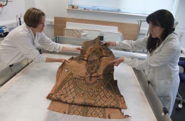 Researchers examining the shroud.