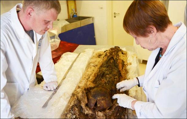The boy's remains are seen as being accidentally preserved aided by the form of burial in a cocoon of birch bark and copper.