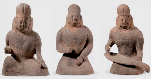 Three female musicians with distinctive hats to their costume. (China Daily)