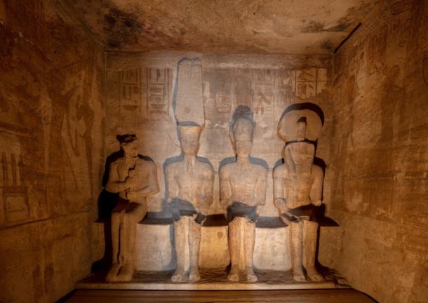 Sunlit statues in the inner sanctuary of the Great Temple at Abu Simbel.