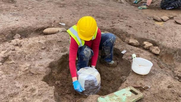 The Bronze Age burial urn about to be removed from where it was found, a tricky process! Source: Fadó Archaeology