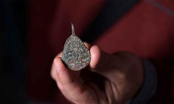 Dr. Eitan Klein, Archeologist and Deputy Director of the Antiquities Theft Prevention Unit for Israel Antiquities Authority, holding the Byzantine-amulet under investigation.