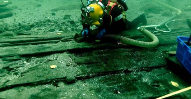 Medieval cog shipwreck underwater excavation showing divers at work on Sv&aelig;lget 2 