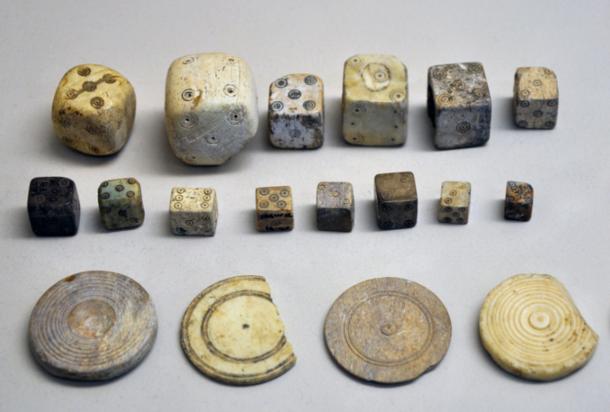 A collection of Roman bone dice and gaming counters from the Gallo-Roman Museum of Saint-Romain-en-Gal, France