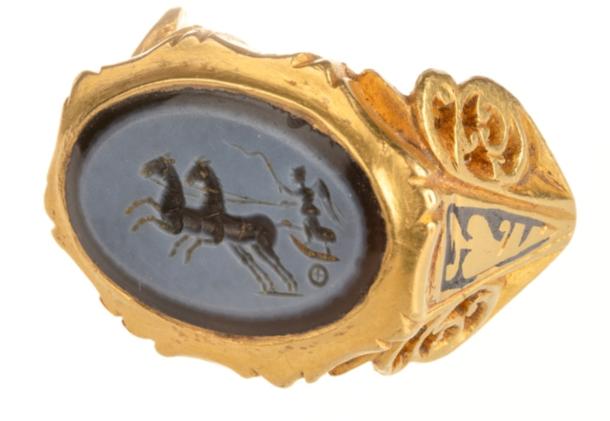 The Roman gold finger ring with a dark blue and light grey nicolo engraved gem depicting Victory